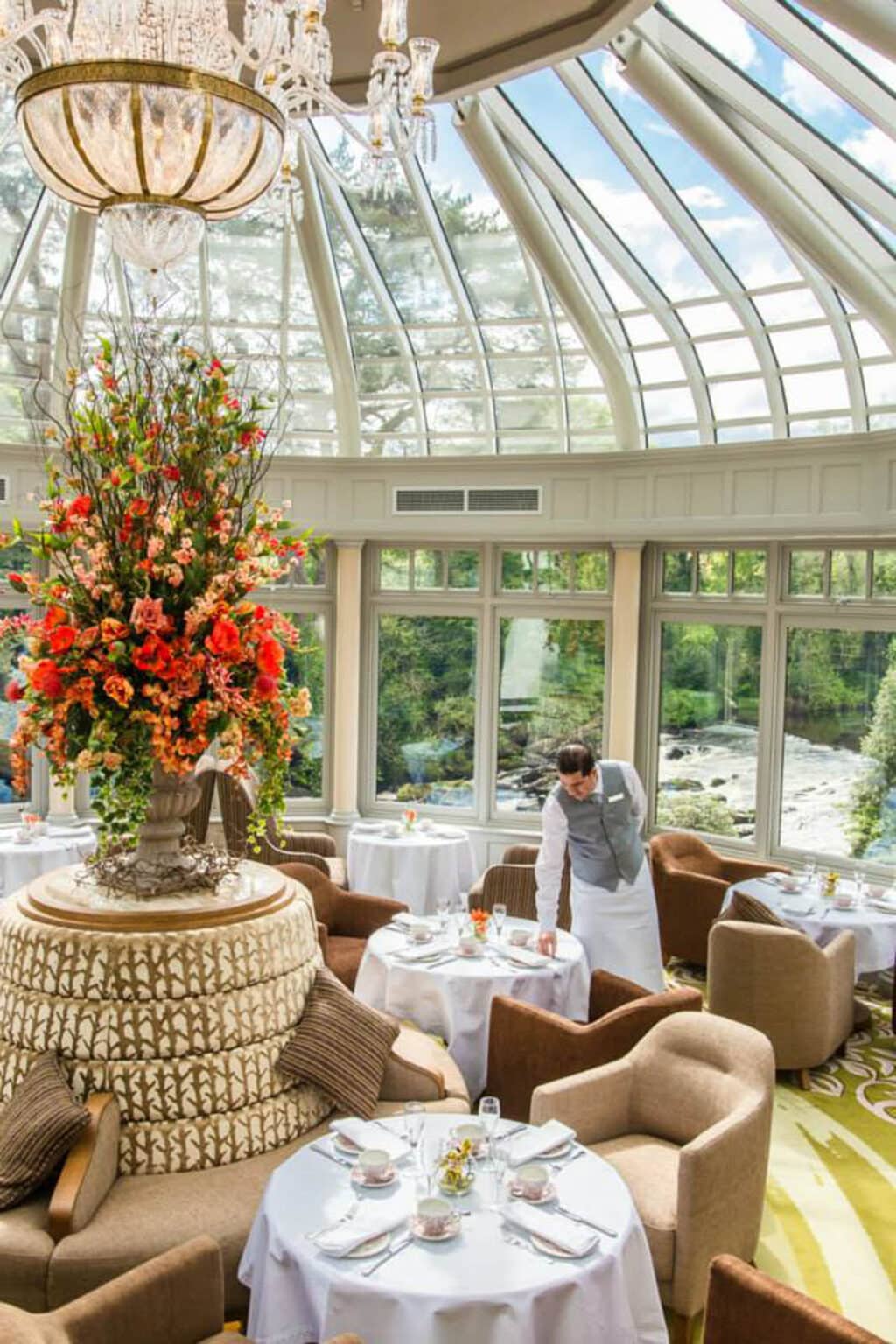 Luxury hotel lounge inside a bright, classic hardwood orangery.