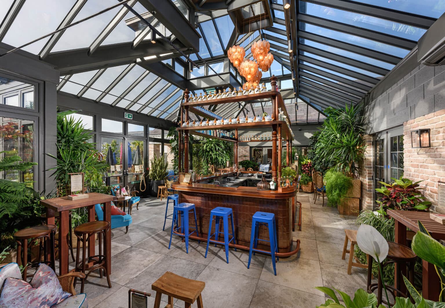 Bespoke glazed extension used as a stylish, bright bar and lounge area.