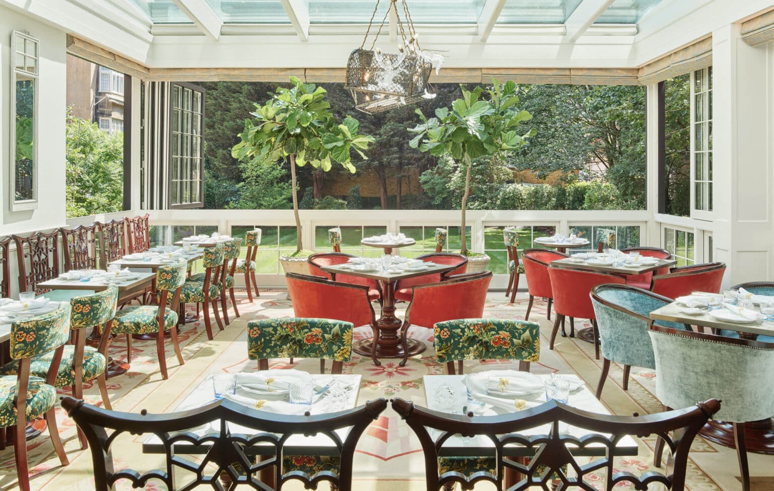 Spacious restaurant interior inside a large commercial conservatory.