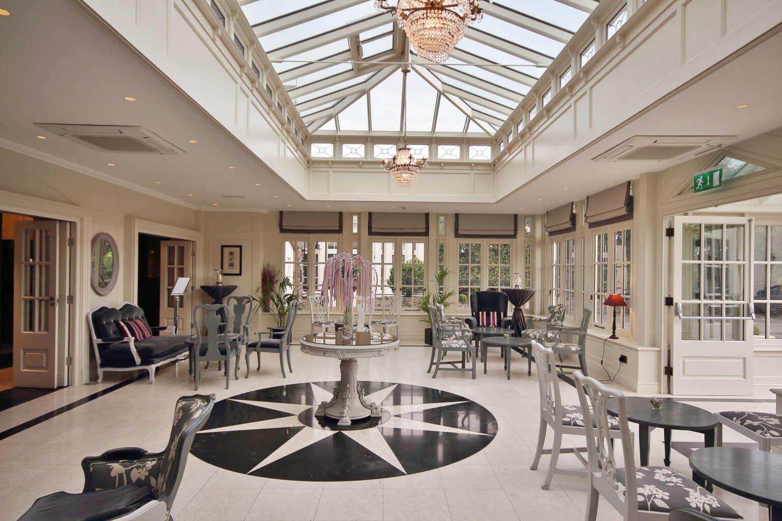 Commercial orangery for a hotel restaurant, with a high glass roof.