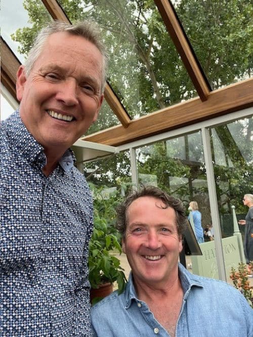 Mervyn Montgomery and Diarmuid Gavin, smiling together inside a greenhouse.