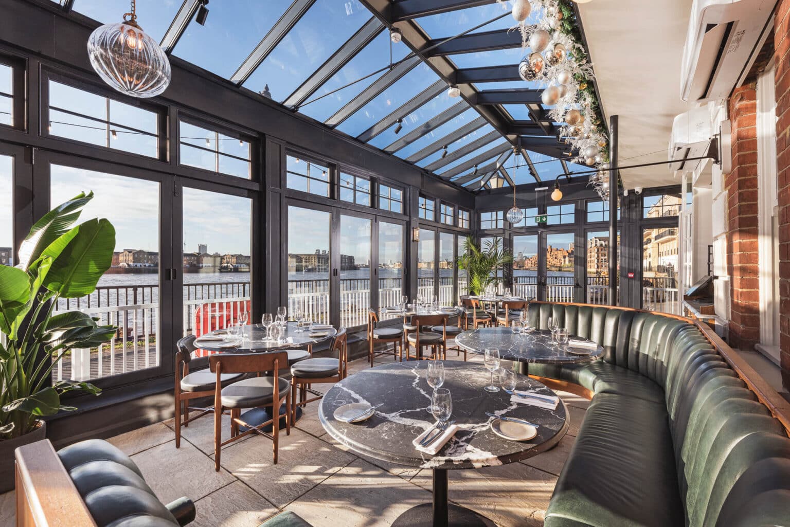 Rooftop restaurant bar in a glazed conservatory with panoramic views.
