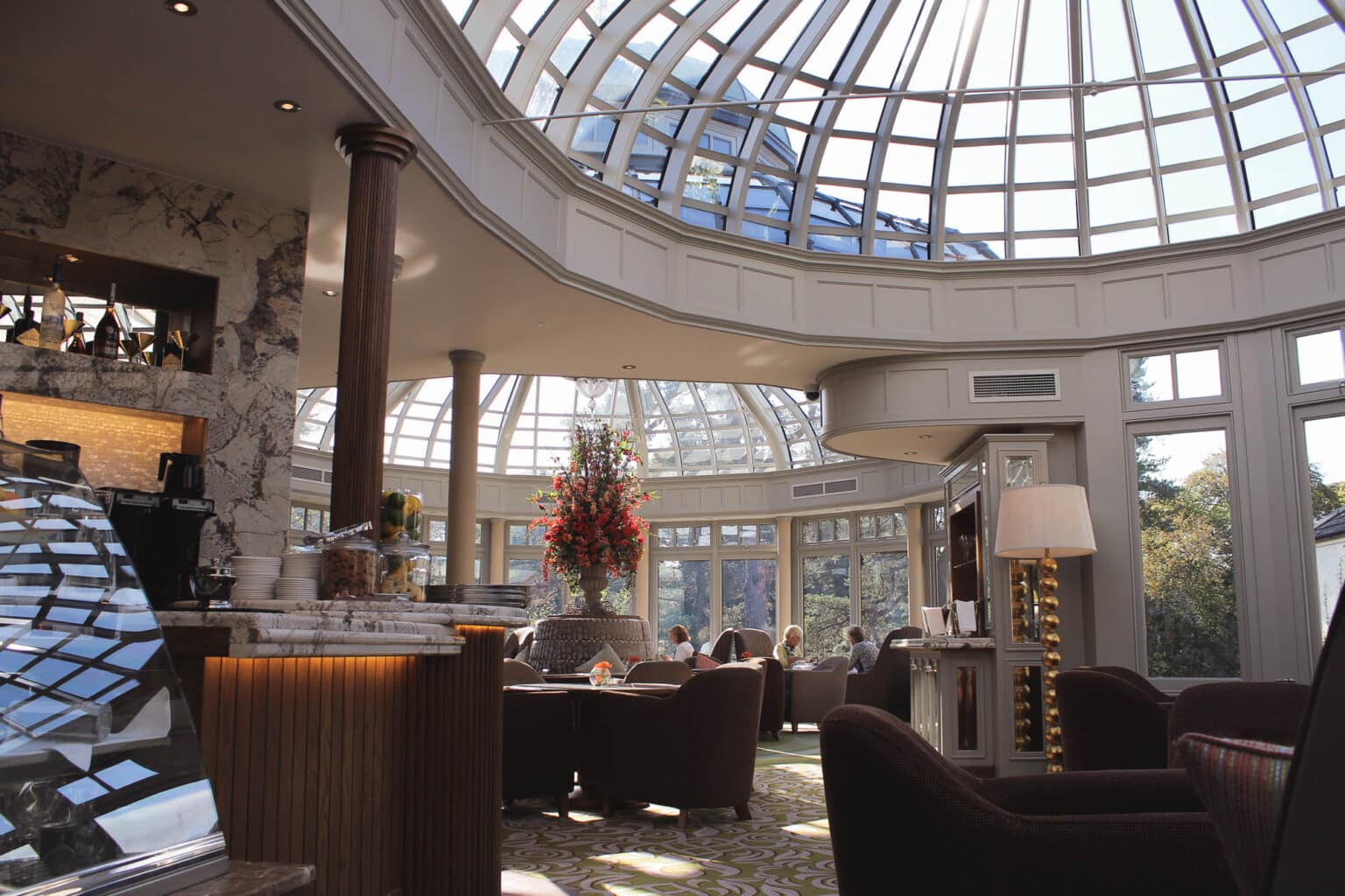 Interior of a luxury hotel bar inside a bespoke curved conservatory.