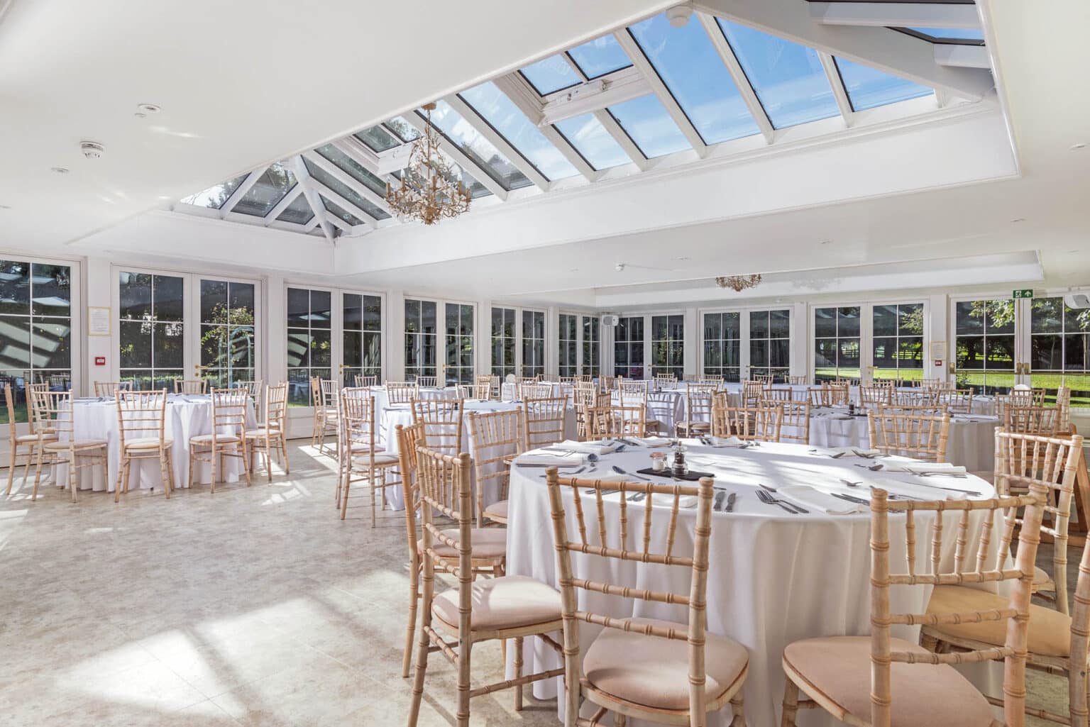 Interior of a commercial conservatory set for a wedding reception.